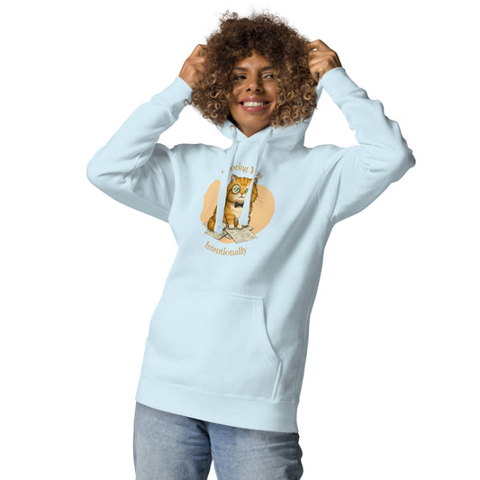 Woman modeling a unisex sky blue hoodie with a design of a cat wearing a monocle and the words 'Ignoring You Intentionally'. Front View.