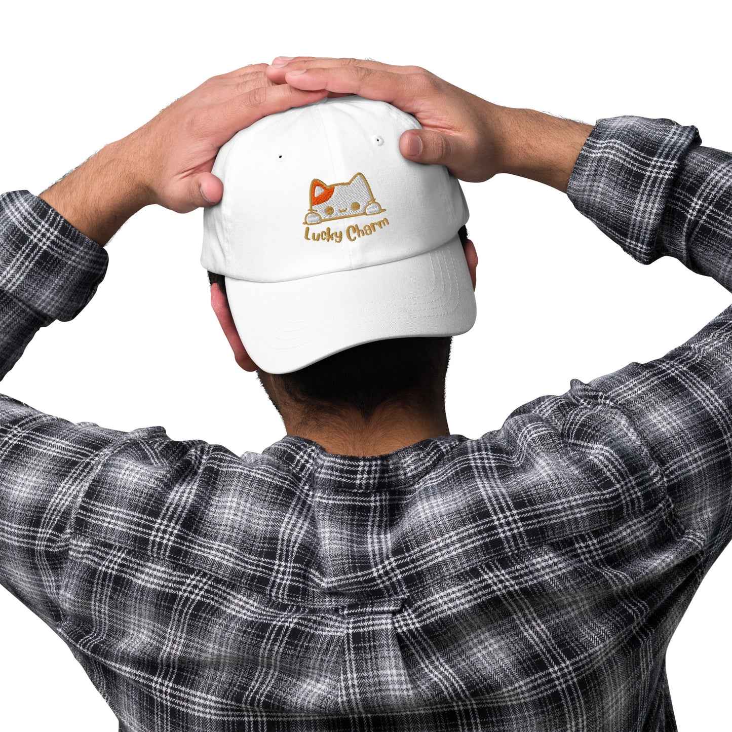 Man wearing a white cap with a design of a cat's face and the words 'Lucky Charm'.