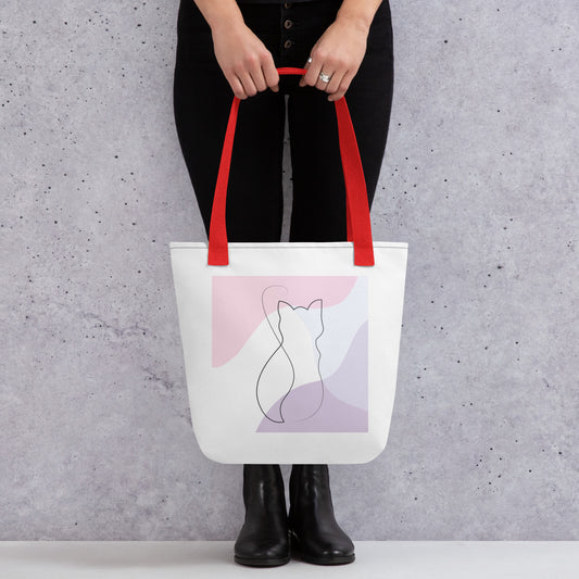 Front View of a tote bag with a design of a cat outline. Red Handle.