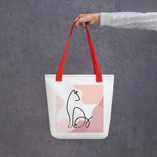 Front View of a tote bag with a design of a sitting cat outline. Red Handle.