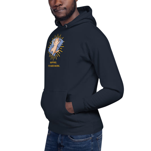 Man modeling a unisex navy hoodie with a design of a cat sleeping and the words 'Napping. It's Hard Work'. Side View.