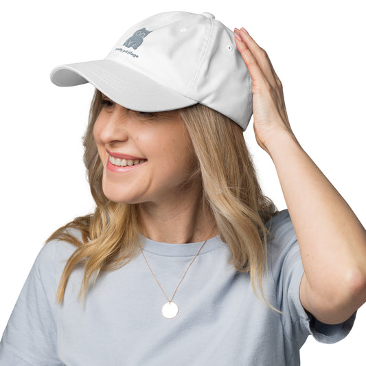 Woman wearing a white cap with a design of a sitting cat and the words "Pretty Privilege".
