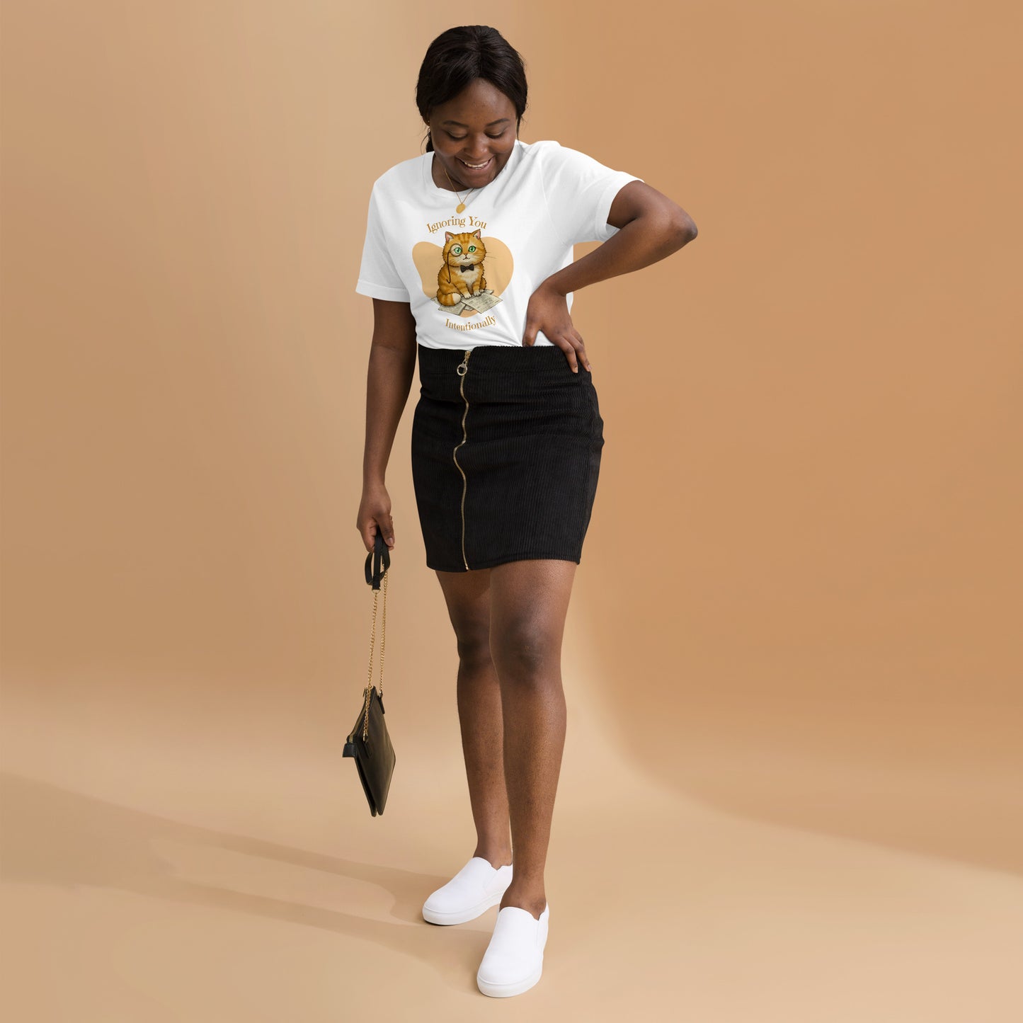 Woman wearing a white Ignoring You Intentionally Cat T-Shirt.