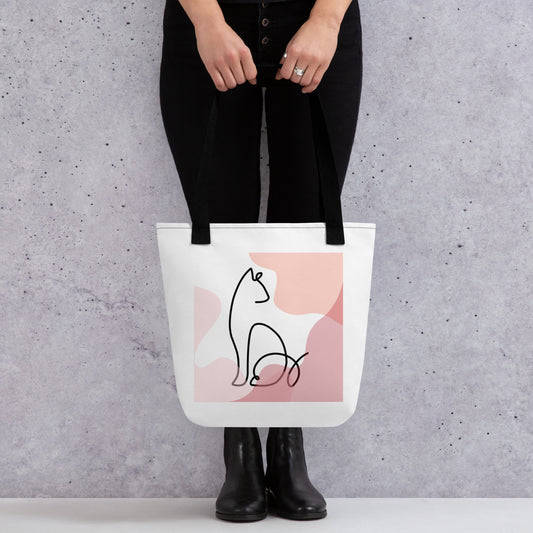 Front View of a tote bag with a design of a sitting cat outline. Black Handle.