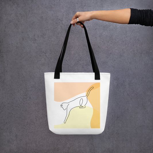 Front View of a tote bag with a design of a cat outline playing. Black Handle.