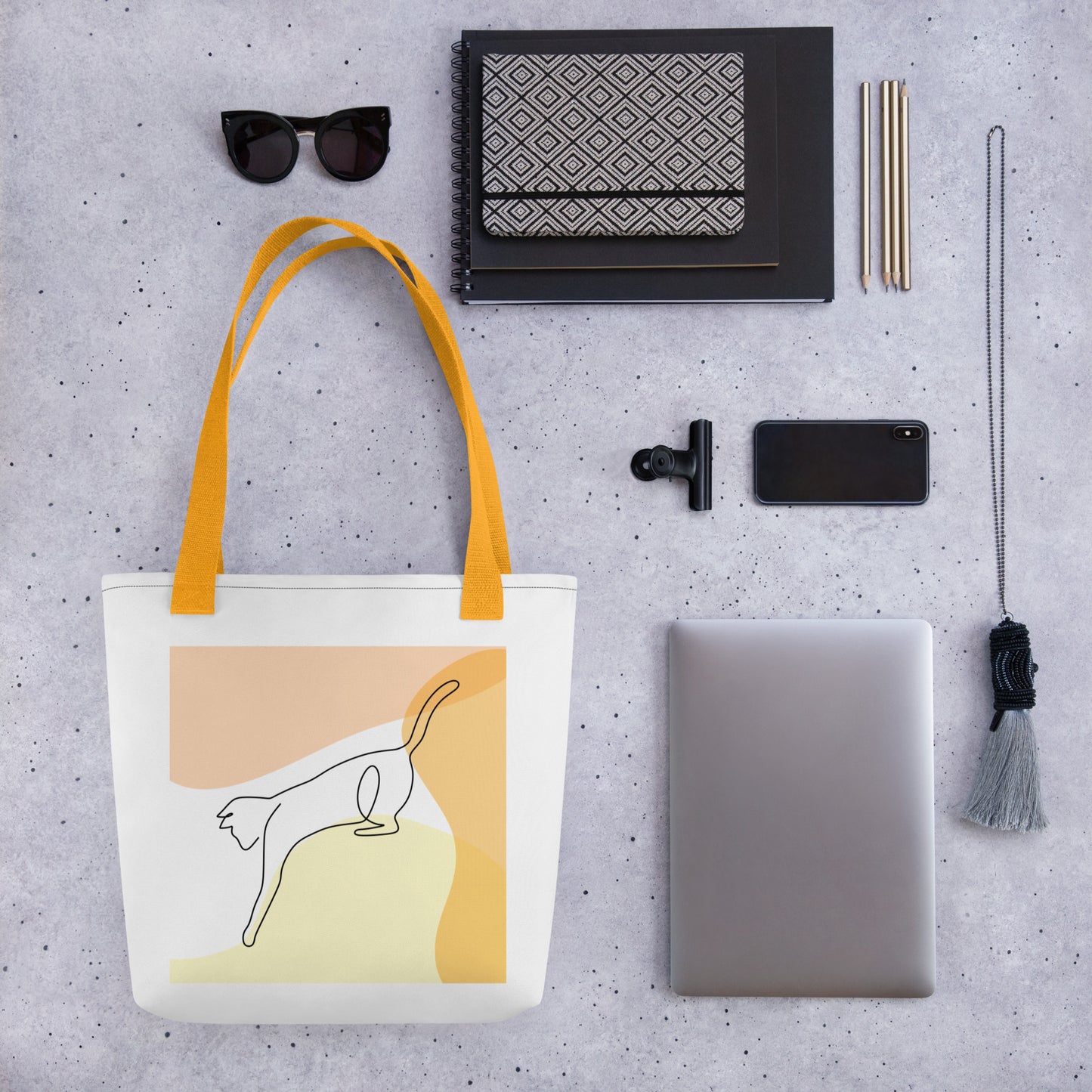 Front View of a tote bag with a design of a cat outline playing. Yellow Handle.