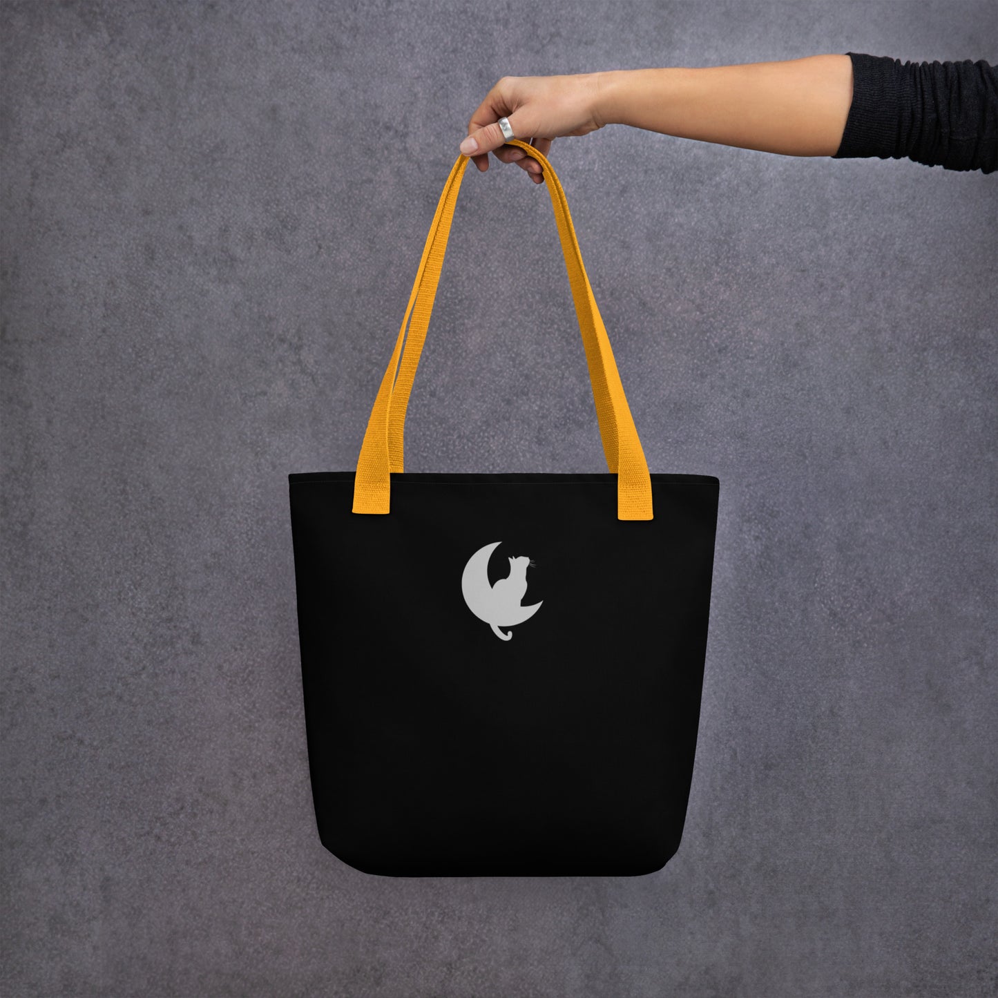 Back View of a black tote bag with a design of two stargazing cats. Yellow Handle. 
